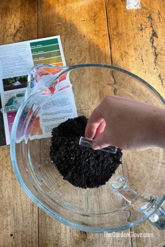 removing a small amount of soil from sample to use for Ph test