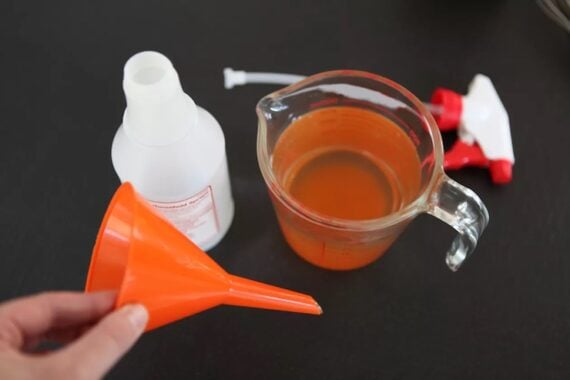 red pepper spray solution prepped to go into a spray bottle