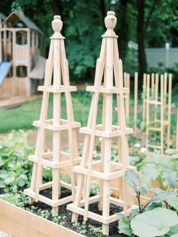 wooden trellises in a raised bed garden