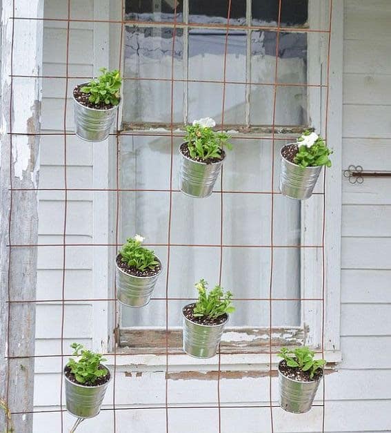 simple diy vertical garden idea using a old fence panel to hang small planter pots