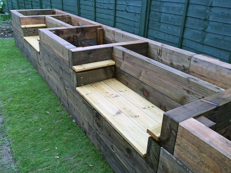 combination outdoor bench and raised garden bed made with railroad sleepers