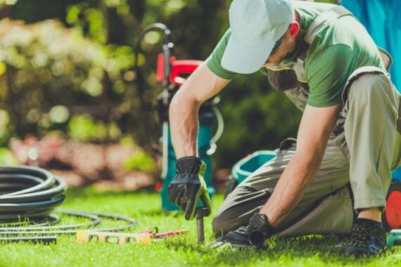 professional working on sprinkler heads