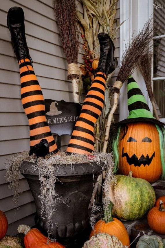 legs in striped stockings and black boots sticking upside down out of a planter 